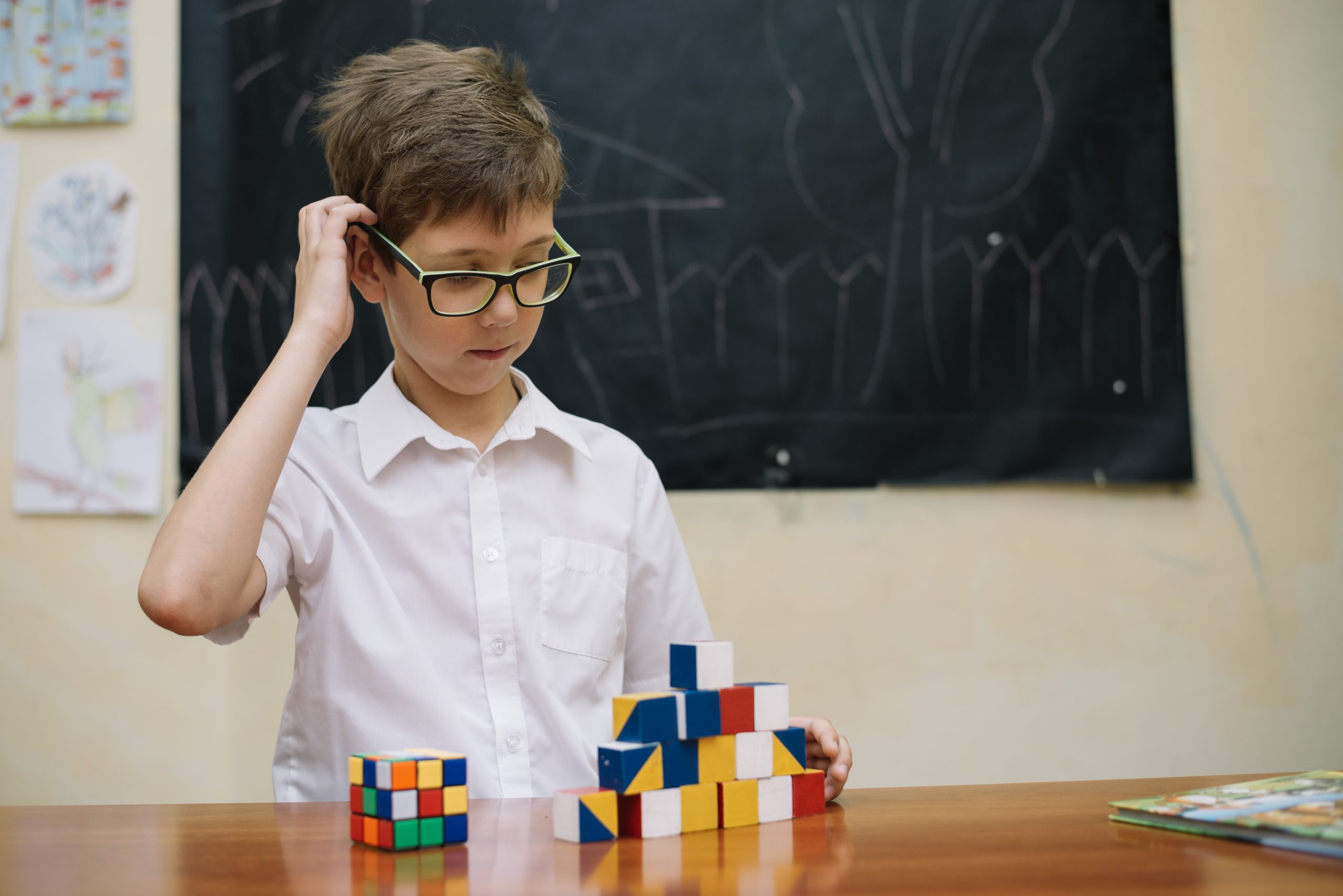 thoughtful-boy-with-puzzle-toys IQ Testing