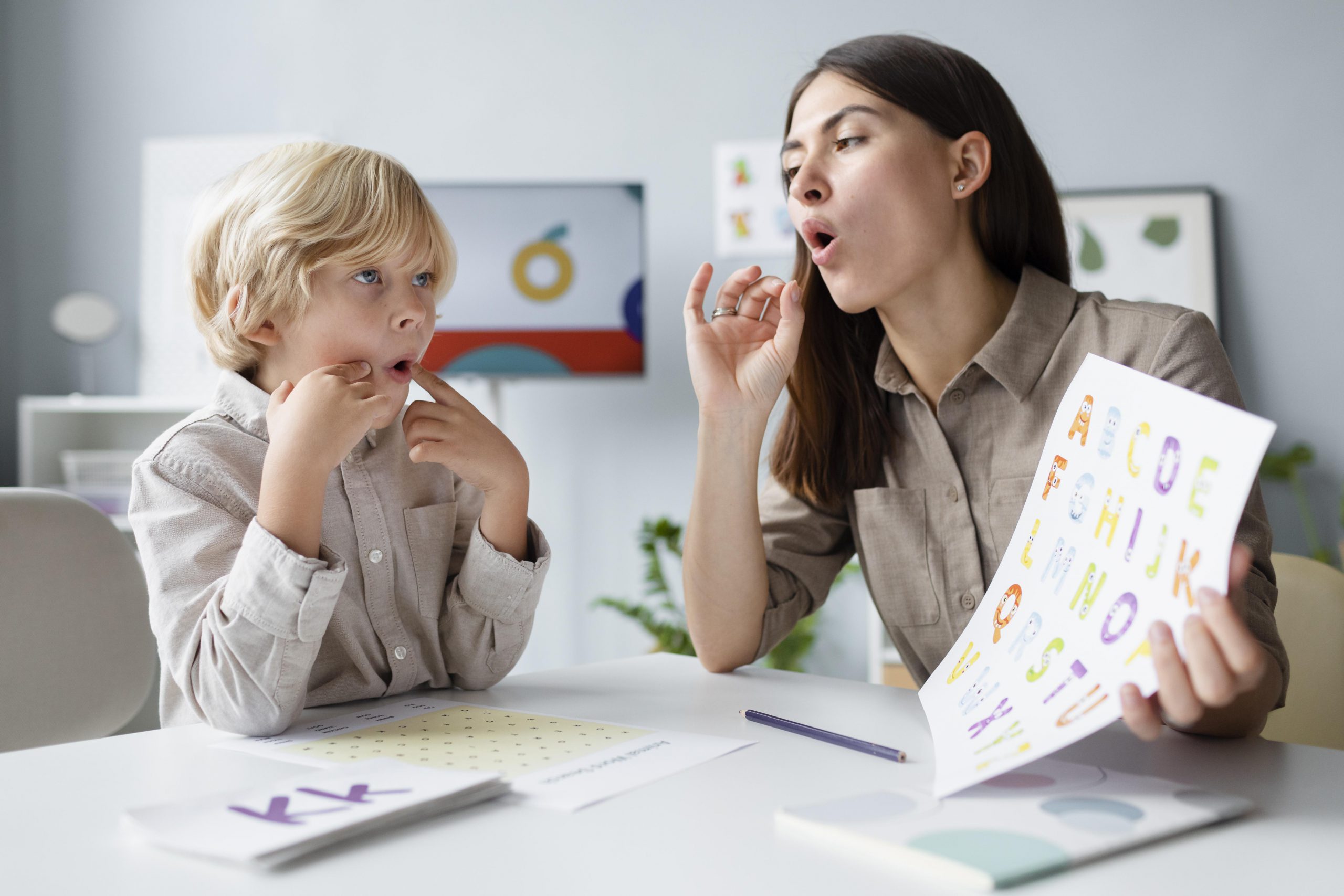 woman-doing-speech-therapy-with-little-blonde-boy Speech Therapy